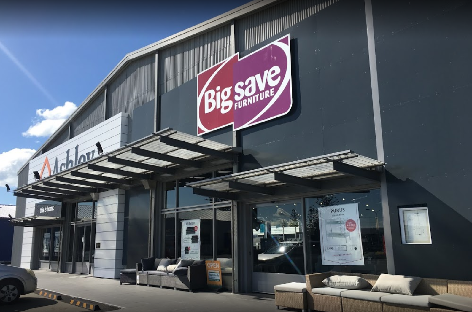 A storefront view of Big Save Furniture commercial building